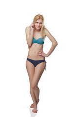 Obraz premium Young Girl In Swimming Suit Speaking at Phone