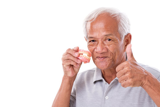senior man with denture, giving thumb up