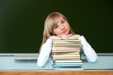 serious girl put her hands on school textbooks