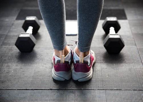 Closeup image of a female legs at gym