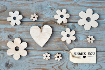 Wooden background with flowers and thank you label