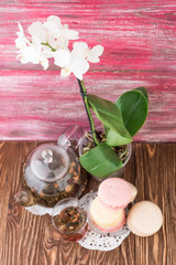 exotic green tea with flowers in glass teapot