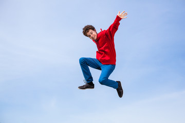Teenage boy running, jumping outdoor