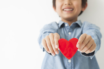 The boy has a red heart