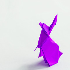Pink purple Origami rabbit isolated on white