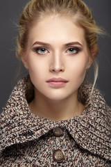 Fototapeta premium Close-up portrait of beautiful girl in knit sweater