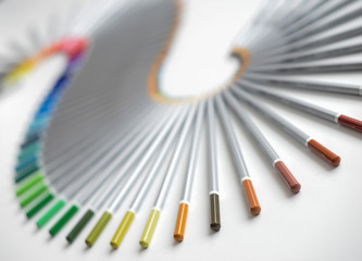 Colorful pencils arranged in a wave isolated