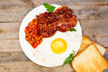 fried eggs with bacon and beans