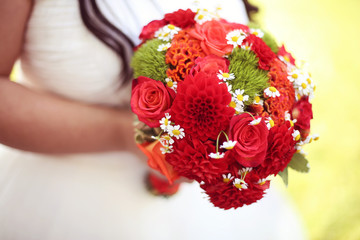 Bride holding red wedding bouquet