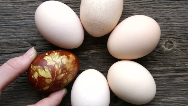 hand choosing bright colored egg