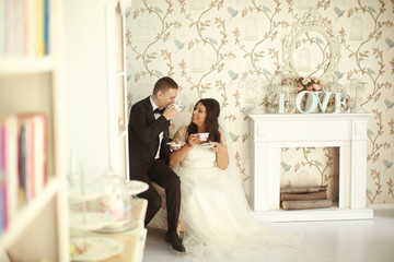 Bride and groom drinking tea