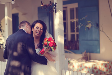 Bride and groom near beautiful house