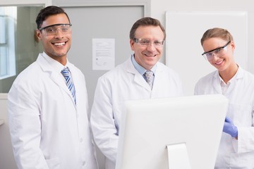 Fototapeta premium Scientists smiling and looking at camera
