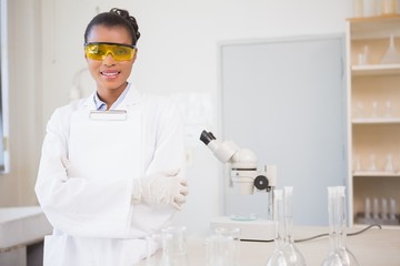 Naklejka premium Smiling scientist looking at camera and holding clipboard