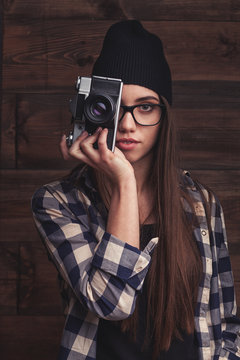 girl in glasses  with vintage camera