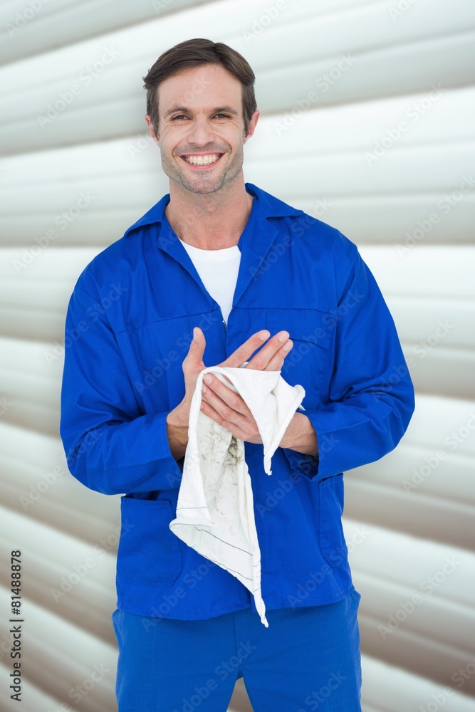 Poster composite image of confident mechanic wiping hand with napkin