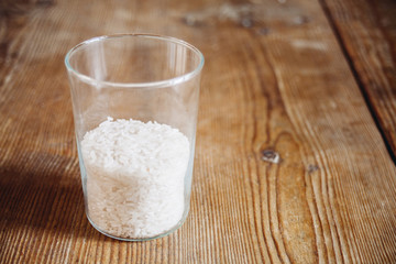 rice in glass on wooden surface