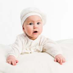 baby girl in  white cap and a jacket