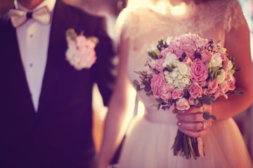 Bride holding her wedding bouquet in the church
