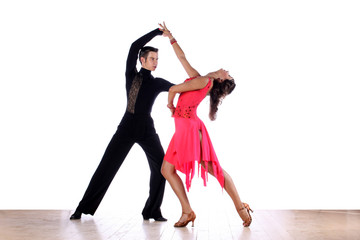 Latino dancers in ballroom against white background