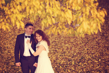 Bride and groom on autumn day 