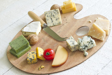 Various types of cheese on white abstract still life