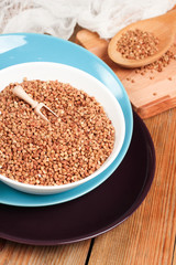 Buckwheat in a bowl on a wooden table