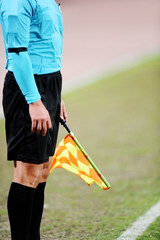 Naklejka premium Assistant referee signaling with the flag