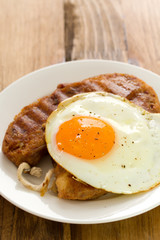 alheira with fried egg on plate