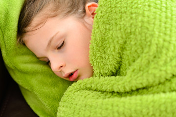 Sick sleeping child girl under a blanket