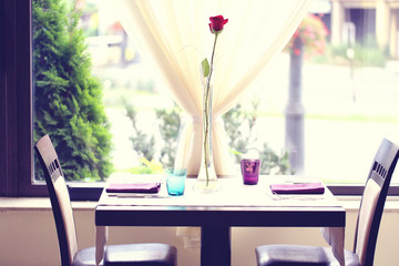 Red rose on table in a restaurant