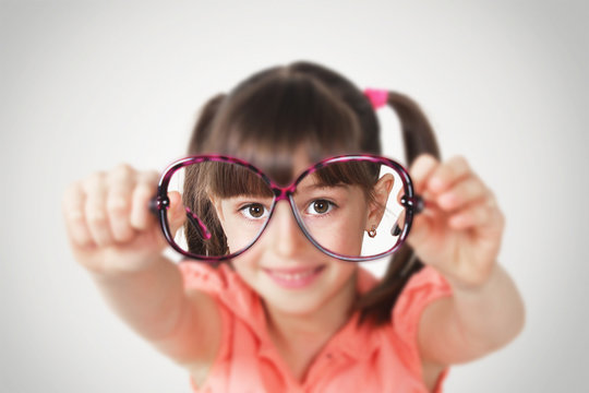 little girl holding eyeglasses, health eyesight concept.Soft fo