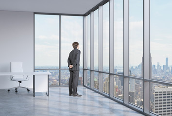 businessman is looking through the corner window. 