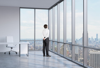 businessman is looking through the corner window.