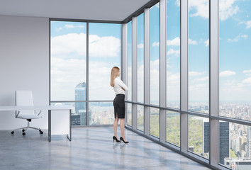 Young business woman is looking through the corner window. 