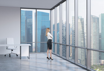 Young business woman is looking through the corner window.