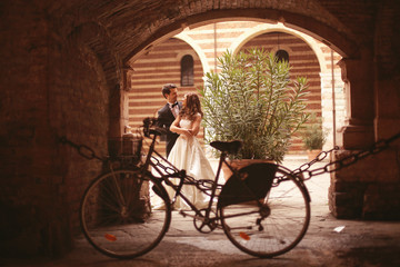 Bride and groom near bicycle