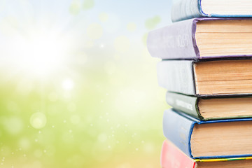 Stack of books on green background