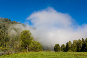 Summer, fog on the river. Altai Mountains.