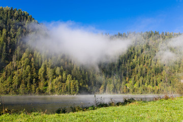 Summer, fog on the river. Altai Mountains.