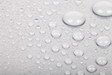 Drops of water on a color background. Gray. Shallow depth of fie
