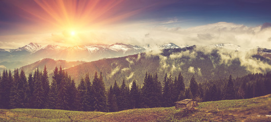 Panoramic mountain landscape in spring with sunlight.
