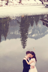 Bride and groom near lake