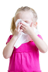 sick child wiping or cleaning nose with tissue isolated