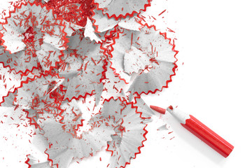 Sharpened pencil and shavings. Red, black and white colors.