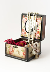 Wooden casket with jewellery on white background