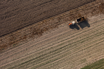 Fototapeta na wymiar aerial view of harvest fields with tractor