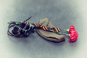 Carnation, George Ribbon, military binoculars and field cap