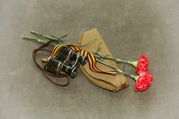 Carnation flowers, George Ribbon and military binoculars