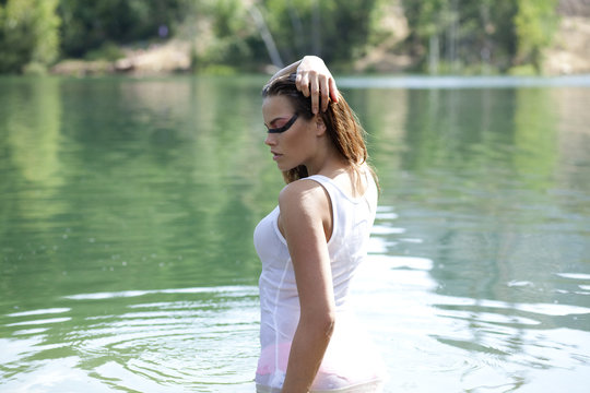 Young brunette woman in t-shirt in a river water